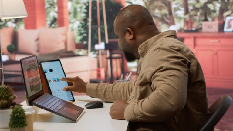 Small business team gathered around a phone working out what to do when your website breaks