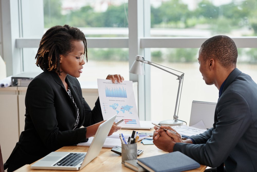 Accountant explaining filing options to two small business clients before a deadline