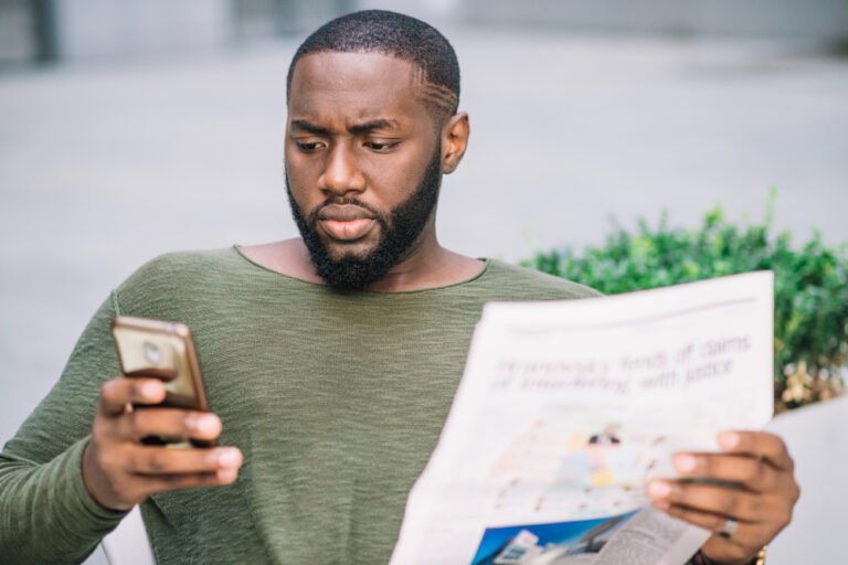 Man abandoning a long form on his phone while queuing