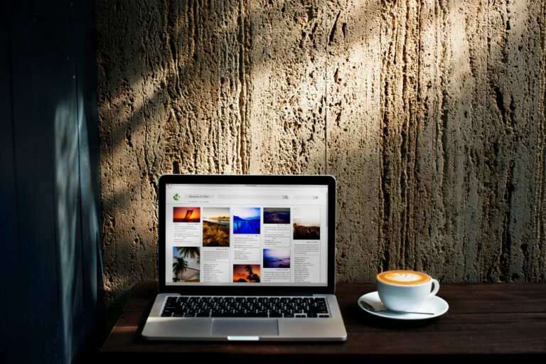 Laptop displaying a clean coaching homepage with a clear headline and portrait