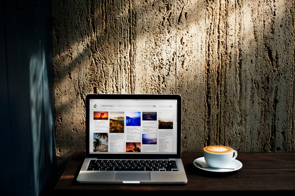 Laptop displaying a clean coaching homepage with a clear headline and portrait