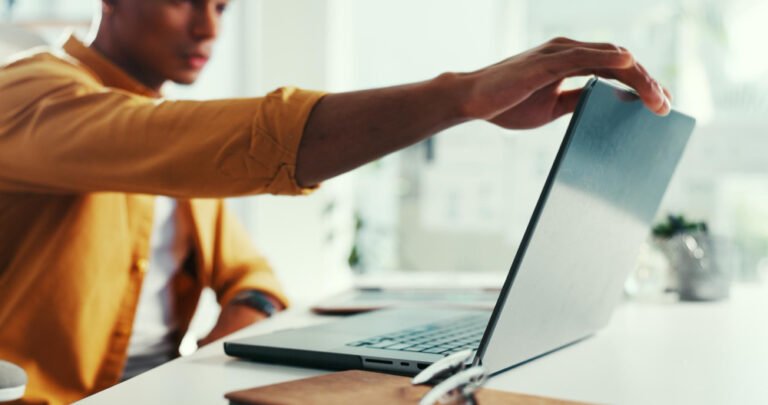Customer closing a browser tab while colleagues work nearby in an office