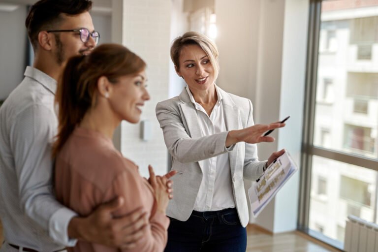 Agent showing a family around a property, the trust a real estate agent website must earn first
