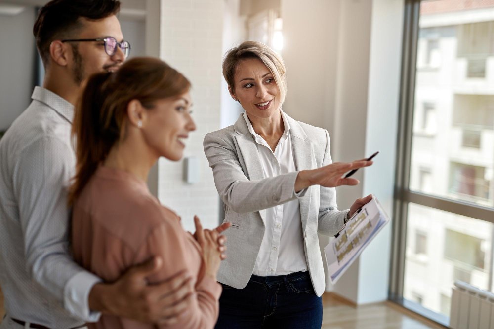 Agent showing a family around a property, the trust a real estate agent website must earn first